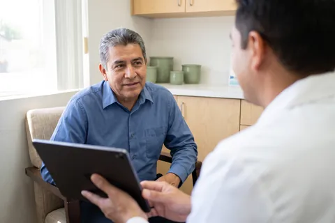 Dentist going over a treatment plan on a tablet with a patient